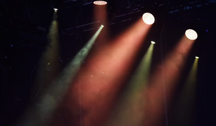 Stage spotlights illuminated in vibrant colours, perfect for a theatre auditorium.