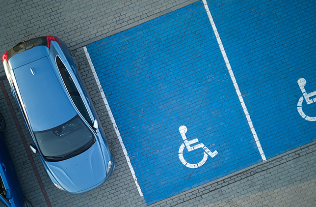 Aerial view of a blue car parked near handicapped spaces at Stevenage Arts and Leisure Centre.