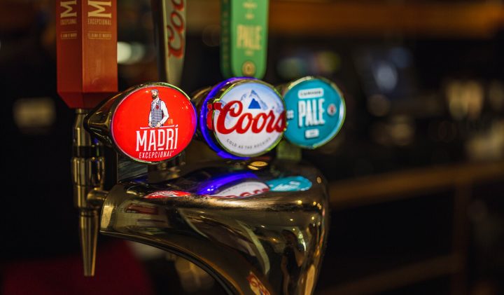 Beer taps labelled Madri, Coors, and Camden Pale on a shiny metal pop-up kiosk dispenser.